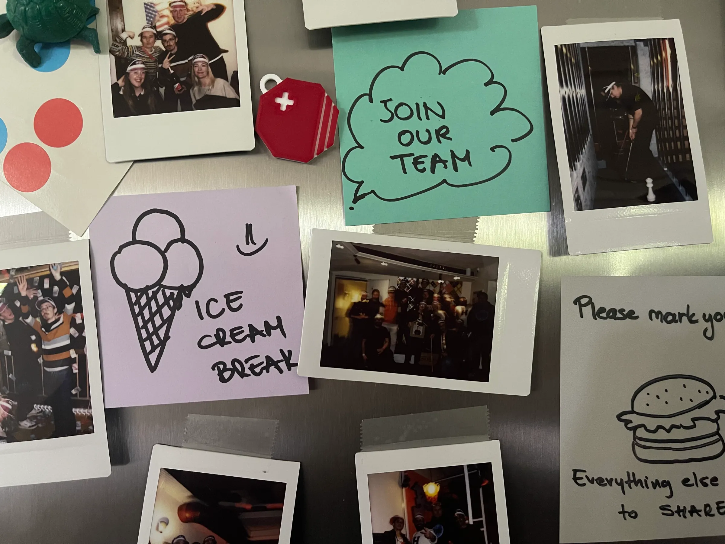 Polaroid photos and handwritten notes from the Swiss Cluster team pinned on a board